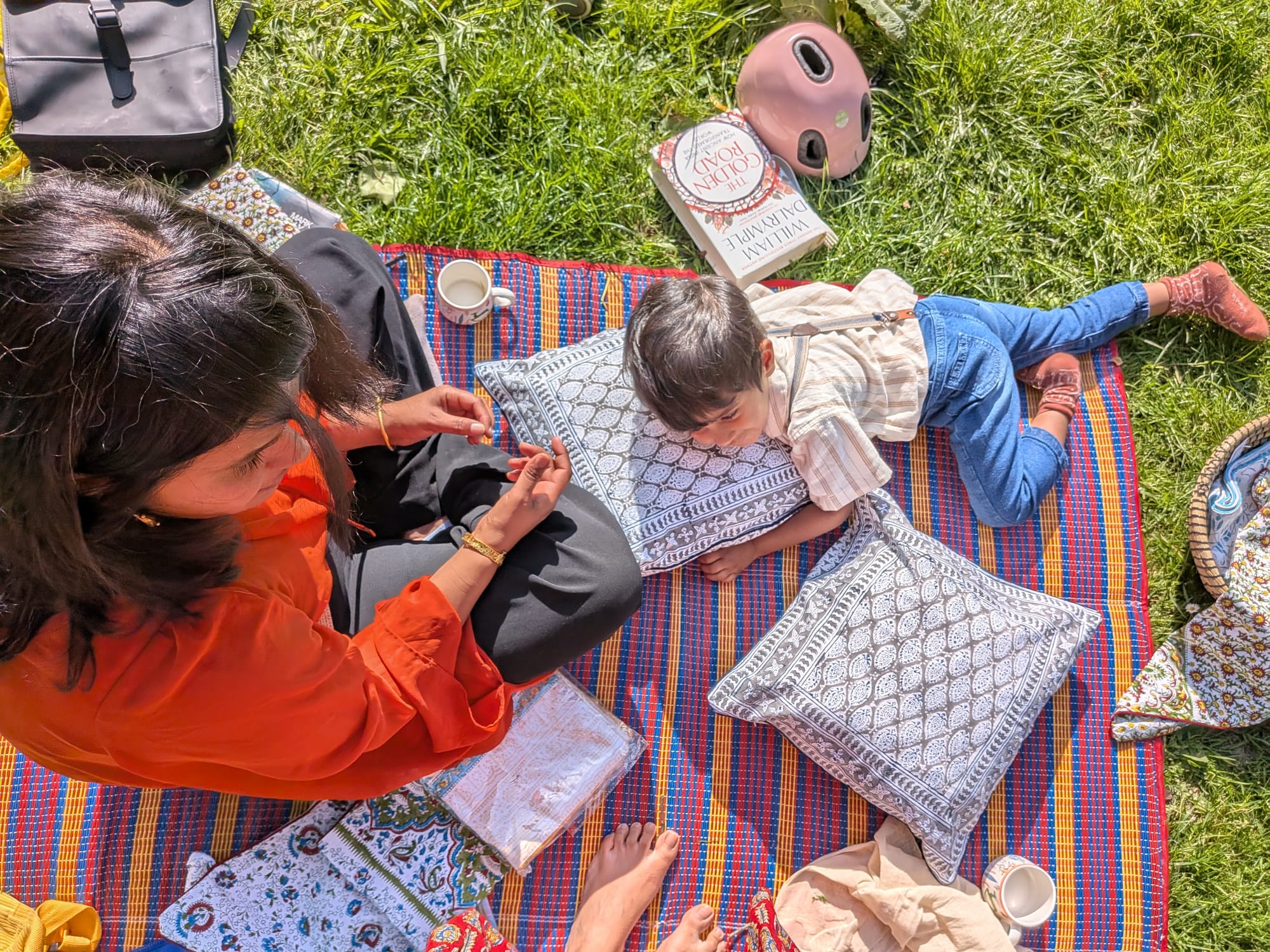 Examining a hand block printed cushion at a picnic in Amsterdam