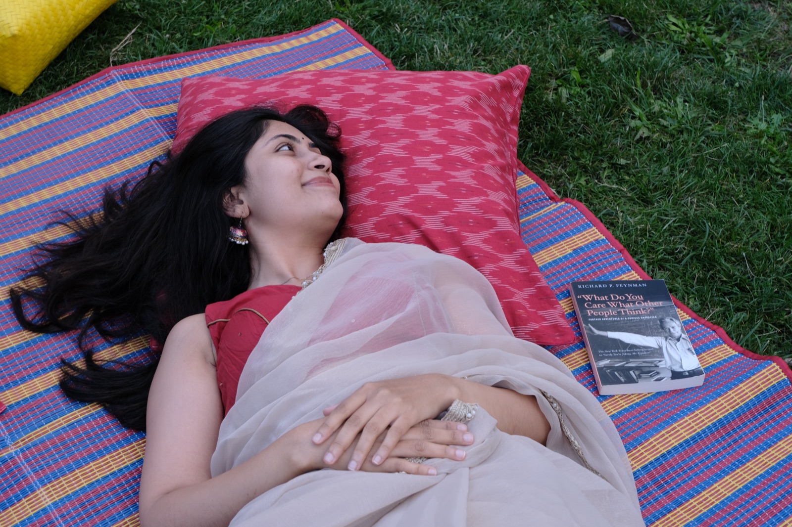 Resting on an Amsterdam picnic blanket beside a Ghar ikat cushion